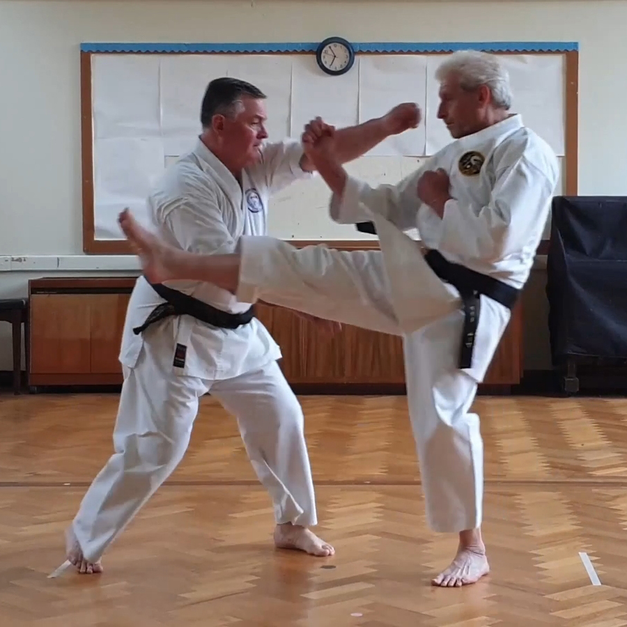 Tori uses Uke's kick to rotate the body and enhance the punch