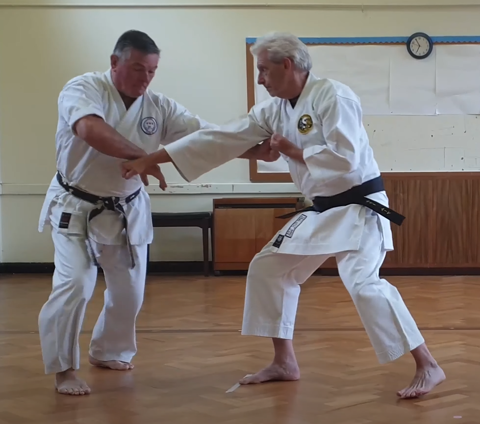 Tori takes control of Uke's attacking arm using the striking hand