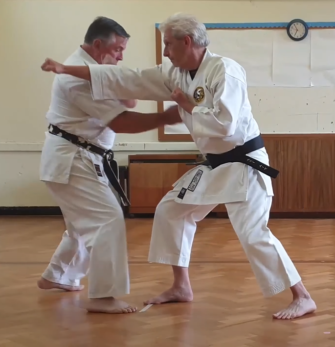 Tori pushes in with Chūdan Zuki and Suri Uke on Uke's covering arm